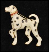 A vintage gold-tone enamel figural brooch in the form of a Dalmatian dog. Measures approx 1 1/2