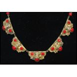 A 1930's Czech Art Deco goldtone necklace set with red rhinestones and glass cabochons with bead and