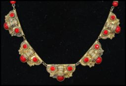 A 1930's Czech Art Deco goldtone necklace set with red rhinestones and glass cabochons with bead and