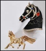 A vintage signed Sphinx gold tone figural brooch in the form of a stallion with tassel tail and