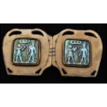 A 1920s large Art Deco Egyptian revival bakelite belt buckle having pierced cartouche with pictorial