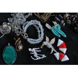 An assortment of vintage costume jewellery, beads and fittings. To include a large enamelled