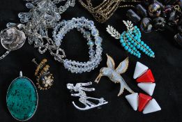 An assortment of vintage costume jewellery, beads and fittings. To include a large enamelled