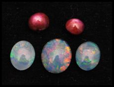 A collection of loose opal triplets x 3 together with star ruby cabochons x 2.