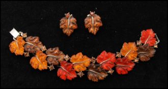 A vintage signed Lisner gold-tone lucite glowing leaves bracelet and earring set. Bracelet