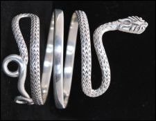A vintage 925 silver bangle in the form of a coiled snake. Weight 76g. Total width 4 inches.