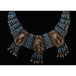 A vintage gold tone Egyptian style bib necklace with three large filigree work panels set with