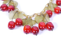 A 1930s bakelite cherry festoon statement necklace strung with a festoon of lifelike red cherries