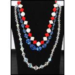 A collection of three vintage glass and crystal necklaces to include a red and white glass bead