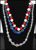 A collection of three vintage glass and crystal necklaces to include a red and white glass bead