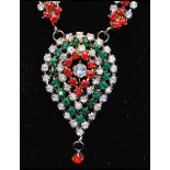 A 1970s Mogul style rhinestone necklace having red white and green rhinestones with a large