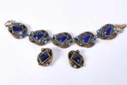 A 1950s Selro Selini gold-tone bracelet and earring set being set with large faceted glass jewels