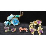 A collection of 1950s enamel jewellery to include violet earrings marked Austria, a large floral