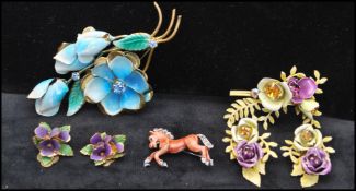 A collection of 1950s enamel jewellery to include violet earrings marked Austria, a large floral