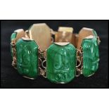 A 1950's gold tone bracelet set with translucent  green glass/ lucite scarab beetle links having a