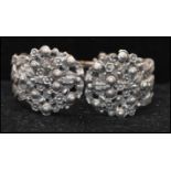 A vintage signed Schiaparelli silver-tone flower basket clamper bracelet bangle. Measures 3 inches