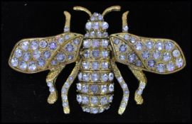 An oversized gold tone crystal set bug bee brooch having a roller clip clasp. Measures 3 1/2