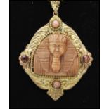 A 1930's Czech gold tone necklace strung with a large pendant set with an Egyptian pharaoh,