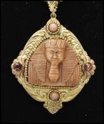 A 1930's Czech gold tone necklace strung with a large pendant set with an Egyptian pharaoh,