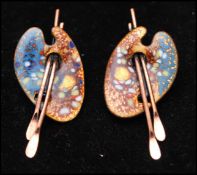 A pair of signed vintage earrings in the form or artists pallets in copper coloured metal with