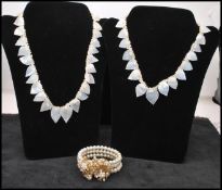 Two 1920s Miriam Haskell style mother of pearl necklaces together with a faux pearl wrap bracelet.