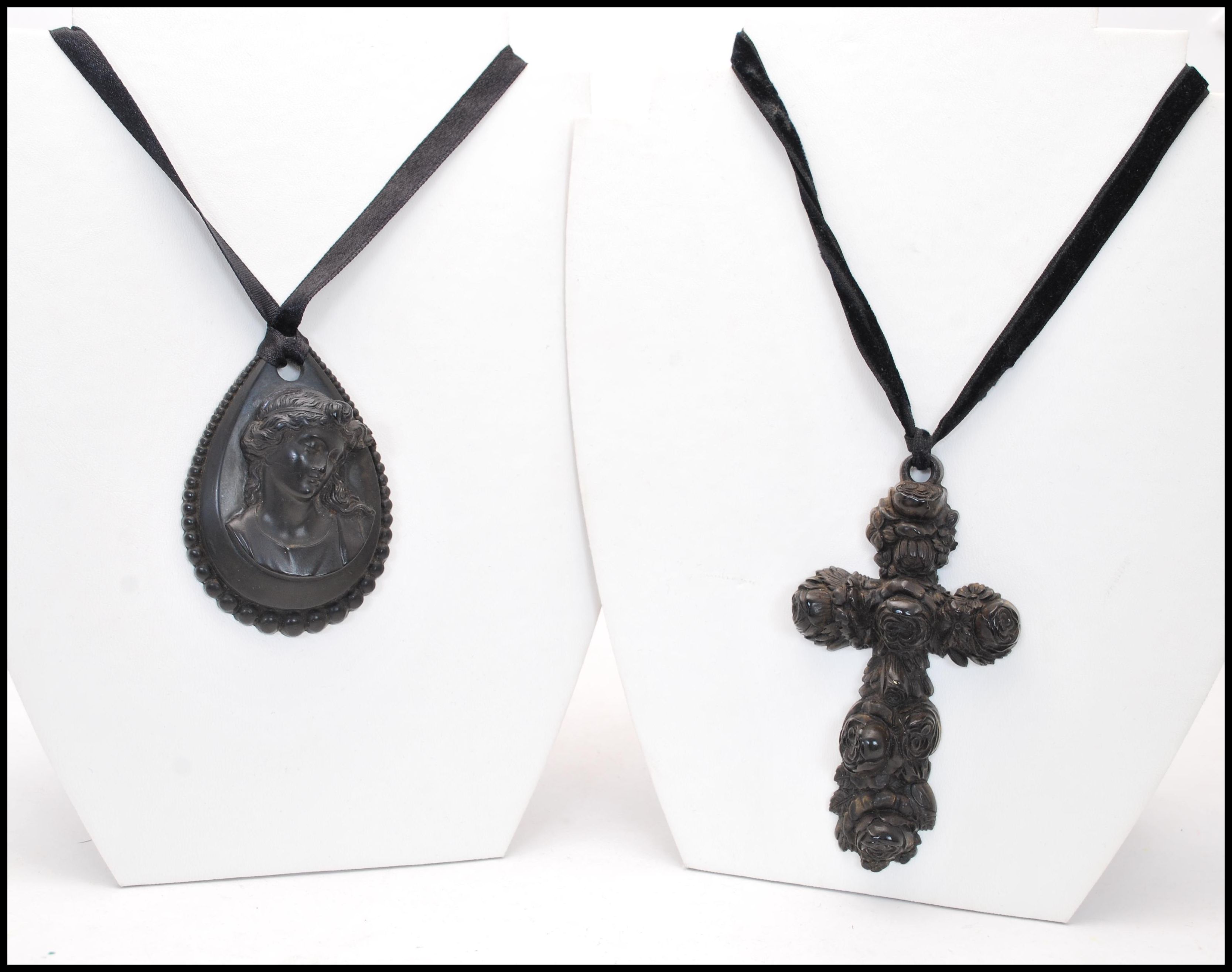 A Victorian large carved Jet crucifix together with a carved Jet cameo pendant. The crucifix being