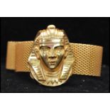 A 1970s signed Miriam Haskell Egyptian revival mesh wrap bracelet having a large pharaohs head