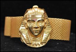 A 1970s signed Miriam Haskell Egyptian revival mesh wrap bracelet having a large pharaohs head