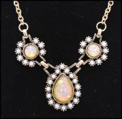 A signed 1970s Sarah Coventry Empress Victorian style necklace being set with faux opal and pearl.