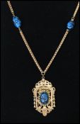 A 1940s signed Miriam Haskell gold tone blue and black art glass pendant necklace with patented