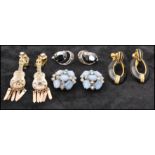 A collection of vintage clip on earrings some signed to include celluloid paste set guitars, satin