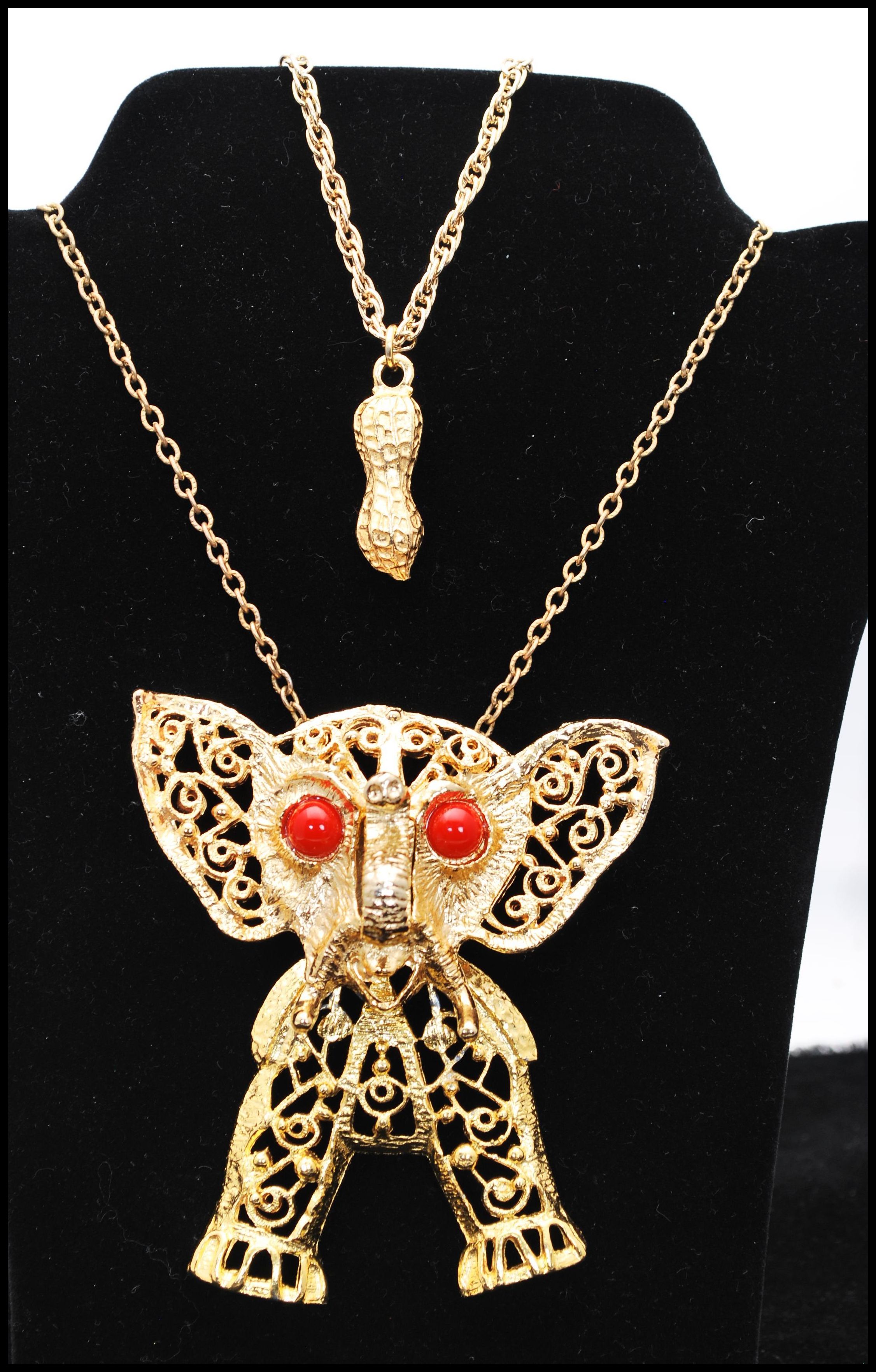 A vintage Delizza and Elster large articulated elephant pendant necklace having coral coloured