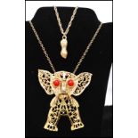 A vintage Delizza and Elster large articulated elephant pendant necklace having coral coloured