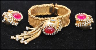 A vintage  1950s Hobé bracelet and earring set consisting of a mesh gold-tone bracelet set with a