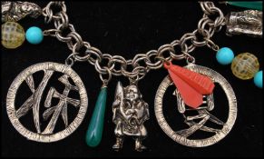 A 1950s Selro Selini seasons charm bracelet strung with large Asian seasons script charms and drops.