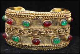 A 1980s signed Chanel Gripoix gold-tone runway bangle bracelet set with green and red Gripoix