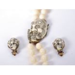 A 1960s signed Selini ivory cream devil necklace and earring set consisting of a 2 strand lucite