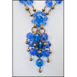 A signed vintage Omar Originals blue twin strand necklace with ornate clip clasp. Measures 7 inches,