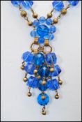 A signed vintage Omar Originals blue twin strand necklace with ornate clip clasp. Measures 7 inches,