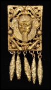 A 1920s yellow metal Egyptian revival brooch pin in the form of a Pharaoh having filigree work