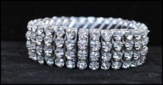 A 1950s stretch rhinestone set bracelet. Marked Empire Made. Measures approx 2 inches unstretched.