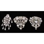 A collection of three 1930s large white metal rhinestone set dress clips. Measures 2.5 inches.