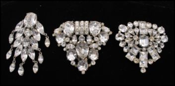 A collection of three 1930s large white metal rhinestone set dress clips. Measures 2.5 inches.