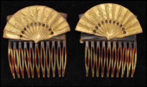 A pair of 1940s signed Miriam Haskell faux tortoiseshell hair combs with gold-tone fan decoration.
