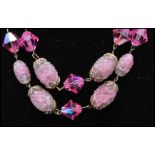 A vintage signed Trifari art glass pink sugar givre bumpy bead and crystal triple strand necklace.