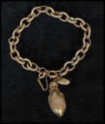 A 1940s signed Miriam Haskell gold-tone acorn charm bracelet having safety chain and spring hoop