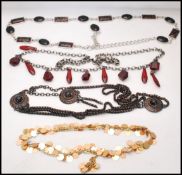 A collection of 1980s jewelled belts to include red lucite drops, sequin, leopard cabochon, agate