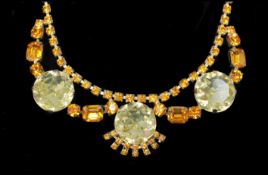 A vintage large amber and yellow rhinestone necklace with rhinestone embellished hook clasp.