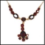 A vintage Czech garnet glass necklace. Measures 15 inches