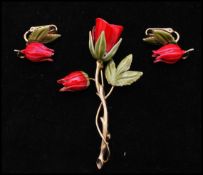 A 1950's gold tone enamel brooch and earring set in the form of tulips. Measures approx 3 inches.